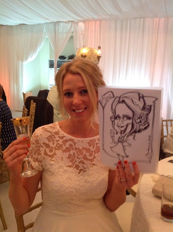 Wedding caricaturist drawing guests at a wedding reception